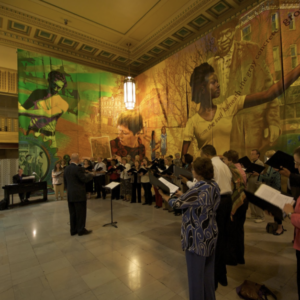 A large mural in a hall with yellow and green colors.