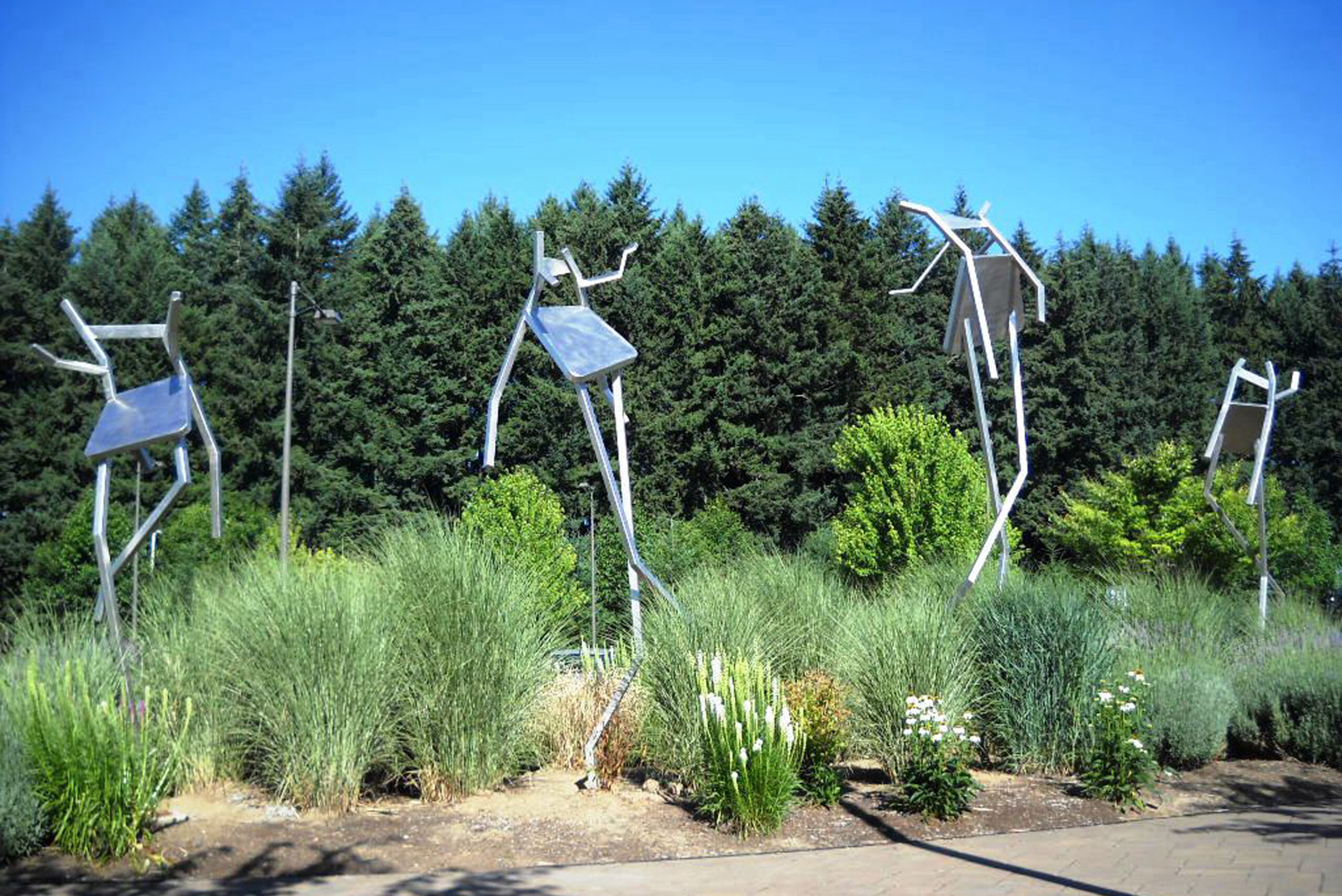 Four huge metal chair sculptures outside