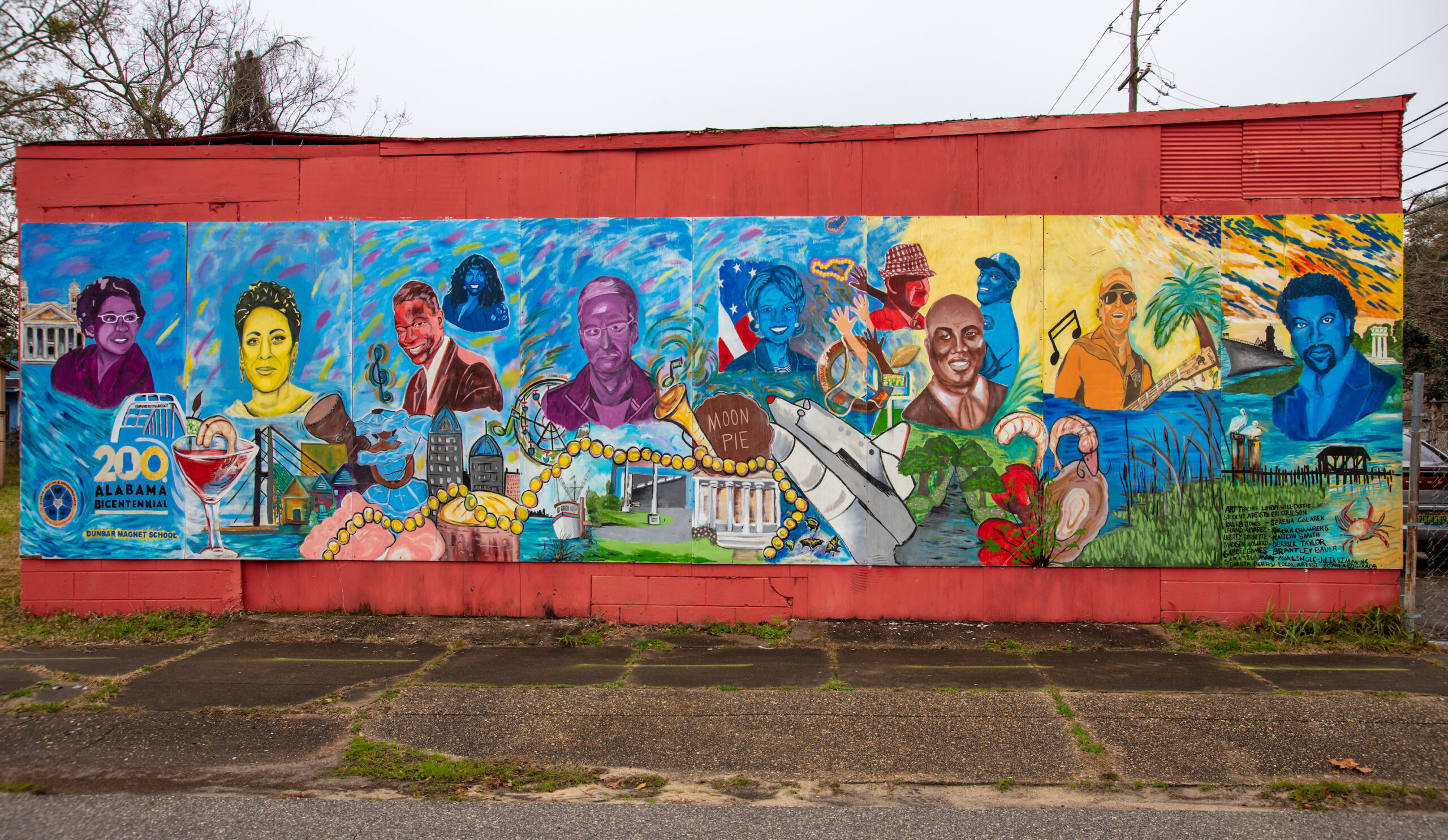 A very colorful mural of several notable Alabama faces.