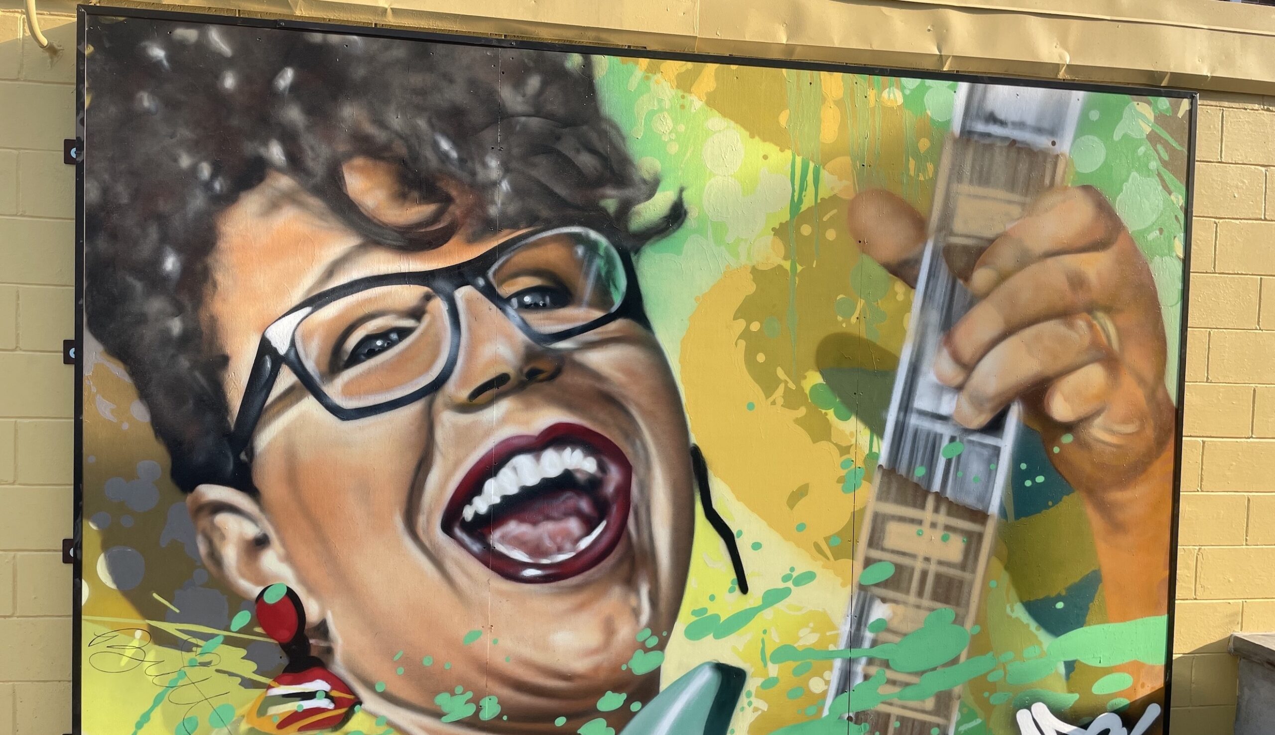 A colorful mural of Brittany Howard from Alabama Shakes