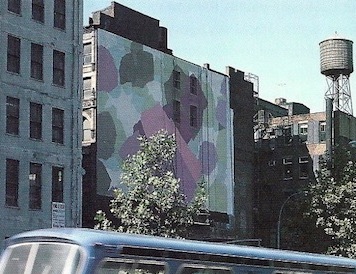 Dorothy Gillespie's New York City Wall installation displayed outdoors. A bus passing by on the street is seen below.