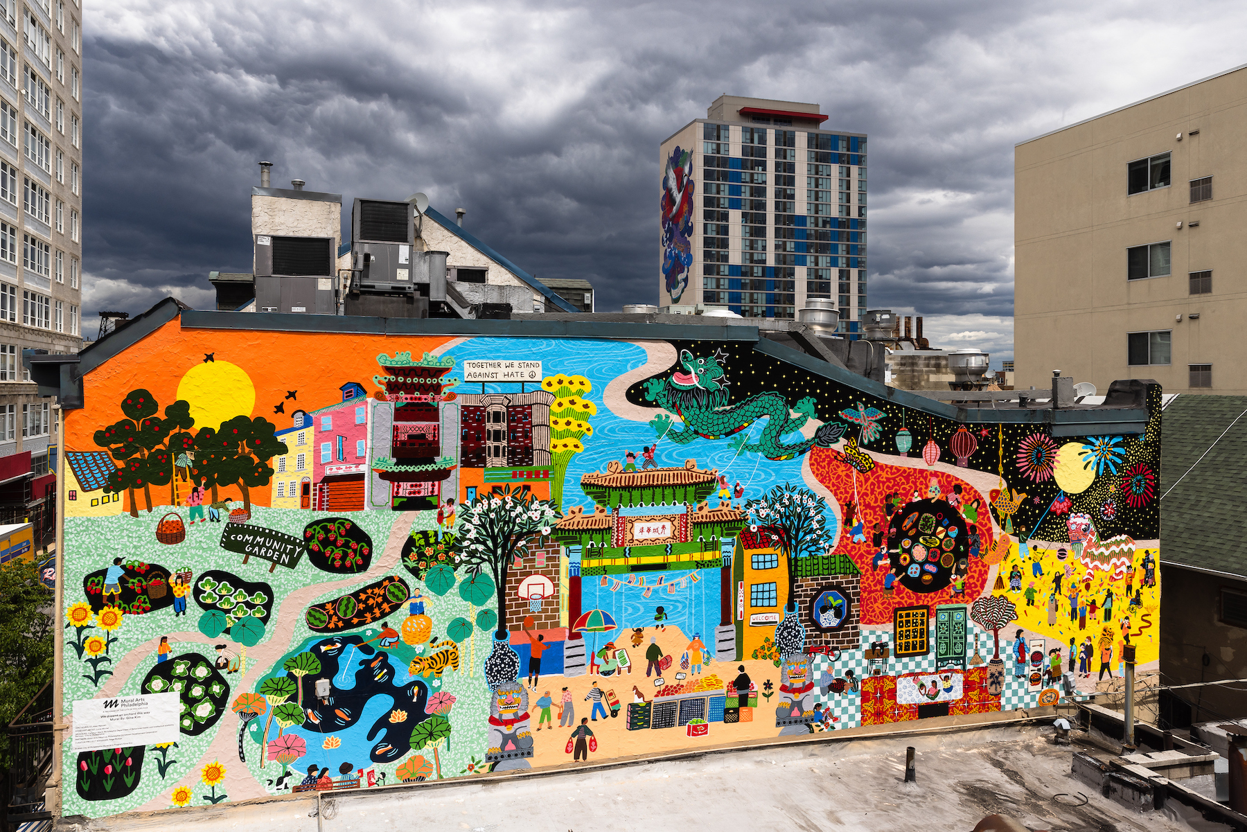 A large colorful mural of an orchard painted on the side of a building in the city.