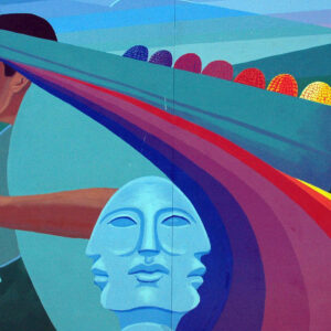 A vibrant mural featuring a person holding a book, set against a colorful rainbow backdrop.