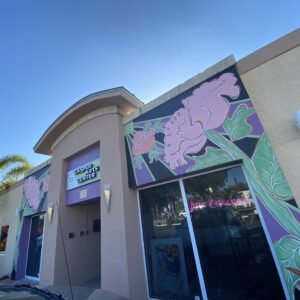 Exterior of a building with pink floral mural