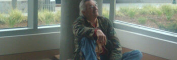 <h3>2011, Rick Bartow rests with his wood carvings Facing The Future Eyes Wide Open for the University of Oregon Ford Alumni Center</h3>