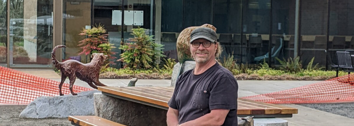 <h3>2022, Brade Rude poses with several of his bronze sculptures part of his work A Common Bond outside of Oregon State University Magruder Hall</h3>