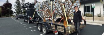 <h3>2024, Crystal Schenk stands with artwork Ballads of Small Worlds created in collaboration with Shelby Davis on installation day at North Valley Complex, Wilsonville</h3>