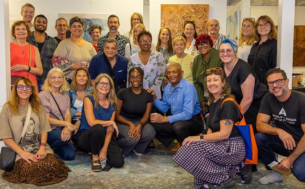 photograph of people in a group smiling at camera